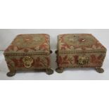 Pair of Regency Footstools with brass carrying handles, brass lion’s paw feet and (worn) needlepoint
