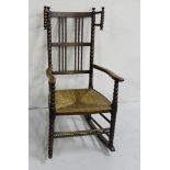 19th C Elm Rocking Chair, with arms and bobbin styled back and frame, wicker seat, 1.07m h x 53cm d