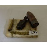 Trench Art – an arrangement of empty cartridges and a piece of shrapnel, mounted on a marble