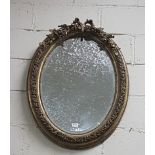 Continental carved wood oval shaped Wall Mirror with raised ornate floral detail, bevelled insert,