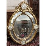 Elaborately Carved Oval Shaped Wall Mirror, featuring 4 round cherub plaques with double borders,
