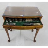 An early 20th Century Walnut Cutlery table with George Butler and Co Silver Plated Cutlery, glass