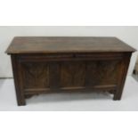 Early 19th large Dark oak Blanket Chest, the panelled front carved with floral detail raised on