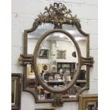 Continental carved wood and gilt decorated Wall Mirror, the central oval bevelled mirror