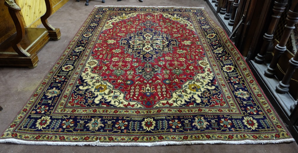 Red ground Persian Tabriz Carpet, with a traditional Tabriz medallion design, size 3.1 x 2.1m