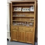 Modern light oak Dresser with a boarded shelf back with adjustable shelves, above three drawers