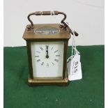 Brass framed Carriage Clock, white dial, with a key