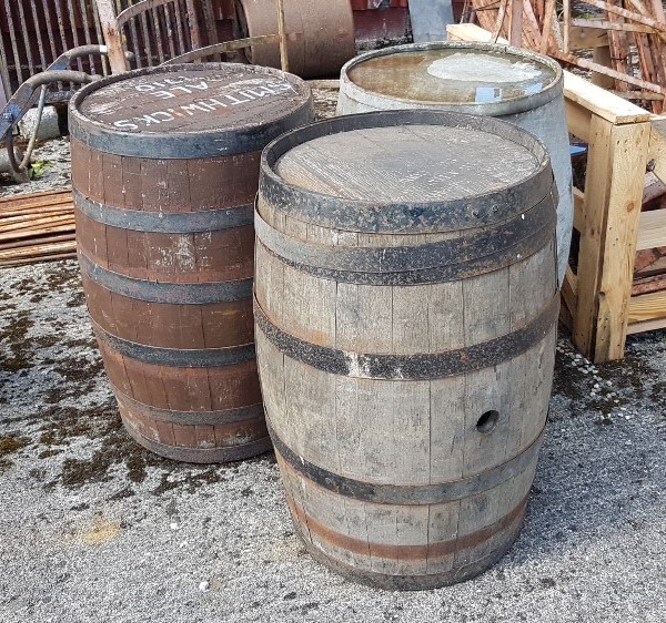 2 x old wooden Ale Barrels, metal bound, each 85cm high and a similar sized steel barrel (3)