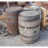 2 x old wooden Ale Barrels, metal bound, each 85cm high and a similar sized steel barrel (3)