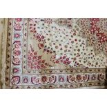 Gold and ivory ground Kashmir Carpet, with a stunning floral medallion design, 3m x 2m