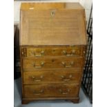 Compact 19thC Oak Bureau, the slope front writing slide opening to an arrangement of drawers, over 4