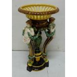 Majolica Table Centrepiece, the fluted upper bowl supported by 3 cherubs decorated with green swags,