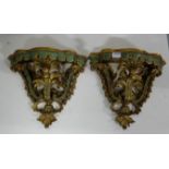 A pair of Continental Polychrome and gilt Wall Brackets, each with serpentine shelf decorated with