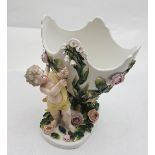 Dresden pot pourri bowl, supported by a cupid figure, raised floral detail, 7”h