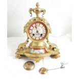Ornate gilt metal Mantel Clock with porcelain painted face and central panel featuring cherubs,