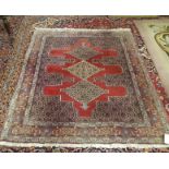 A Persian Floor Rug with three central medallions 1.57m x 1.25m