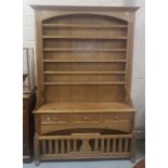 A Lancashire pine "chicken coop" dresser, the upper section fitted open shelves over 3 drawers &