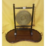 Brass Gong and Striker on a wooden stand & a kidney shaped mahogany Tray with brass handles (2)