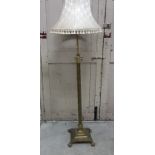 Brass adjustable column standard lamp, on a square base and ball and claw feet and a cream shade