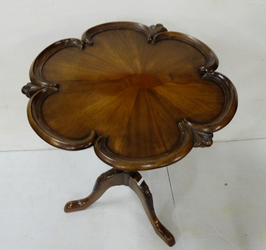 Reproduction mahogany pedestal table with shaped moulded top above a turned & carved column