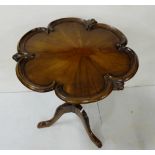 Reproduction mahogany pedestal table with shaped moulded top above a turned & carved column