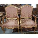 Matching Pair of carved Gilt Wood Framed Armchairs, the backs and seats covered with red and gold