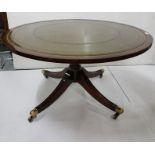 Circular leather topped low sized mahogany occasional Table, with a green leather top, on tripod