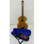 A Manuel Rodriguez six string acoustic guitar and Stentor 10.25" student violin with bow in fitted