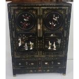 A Chinese black lacquer Cabinet, decorated throughout, the side panels and top with flowers, the