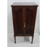 Edwardian mahogany Music Cabinet, the twin doors enclosing three deep drawers, on square tapering
