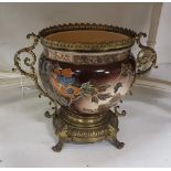 Early 20th C ceramic Flowerpot in an ornate brass frame with carrying handles, the exterior