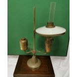 Indian brass table oil lamp with an opaline glass shade, 60cm high