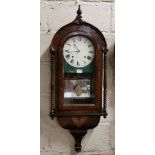 Spring Driven Wall Clock, in a gothic style walnut case with a white dial, over an inlaid base, with