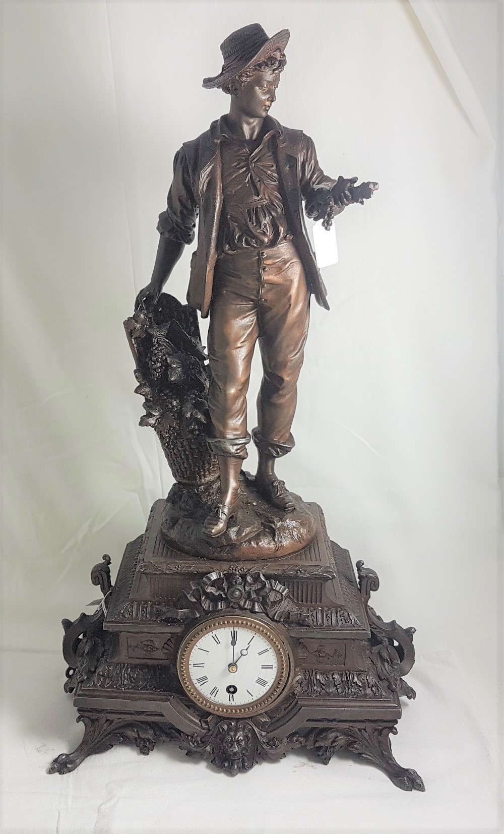 French Movement Mantle Clock, mounted with a bronze figure of a grape merchant, the pendulum being