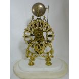 French Brass Framed Skeleton Mantle Clock, with hourly chiming, fixed on an oval shaped white marble
