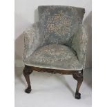 Carved and upholstered tub chair on ball and claw feet, blue floral upholstery, 60cm w x 80cm h