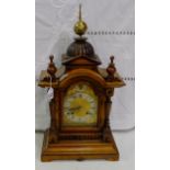 German Mantel Clock with a brass finial above a dome-shaped walnut case, the silvered dial with gilt