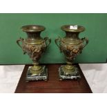 Pair of Bronze Clock Urns, featuring cherubs, on green marble bases, brass toes, 30cmH x 13cmW