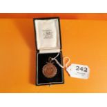 A packet of Trinity College playing cards & a Trinity College bronze medal 1924 (2)