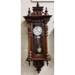 Spring Driven Vienna Wall Clock, in a mahogany case, the pediment featuring a Roman mask, 105cm x