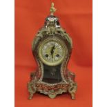 French Buhl Mantel Clock, featuring a red tortoiseshell base, overlaid with brass, strikes on a