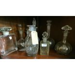 Shelf containing a quantity of various 19th C & later Cut Glass Decanters including one large