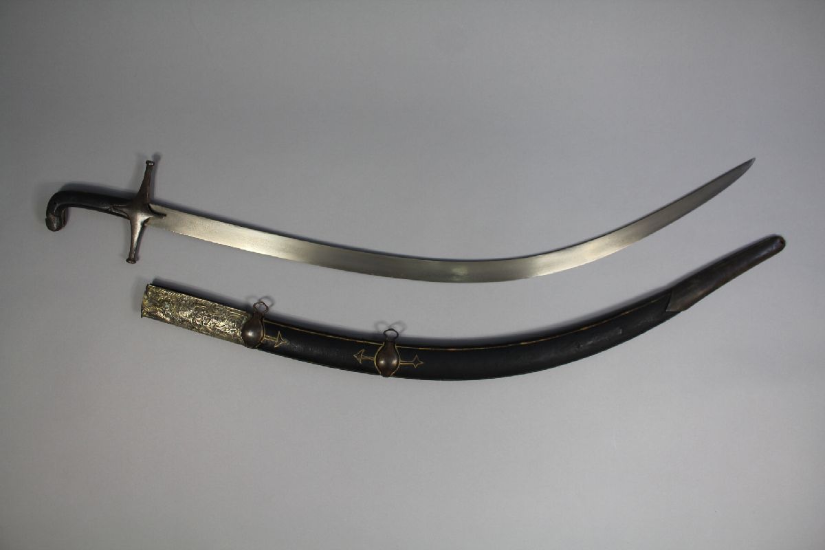 Persian shamshir with scabbard of traditional form. 92cm overall with 79cm curved blade of wootz