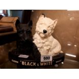 Pair of Black and White Scotch whisky dogs.