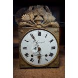 19th C. embossed brass wall clock with enamel dial and Roman numerals.