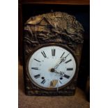 19th C. embossed brass wall clock with enamel dial and Roman numerals.