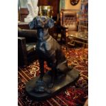 Good quality cast iron model of a seated dog {94 cm x 91 cm W x 40 cm D}.