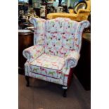 Upholstered wing back deep buttoned arm chair with dog pattern.