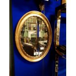 Oval gilt wood wall mirror.