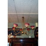 Early 20th C. brass chandelier with six glass holophane style shades.